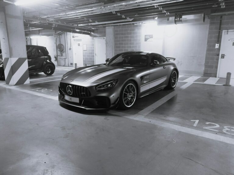 a black and white photo of a car in a parking garage